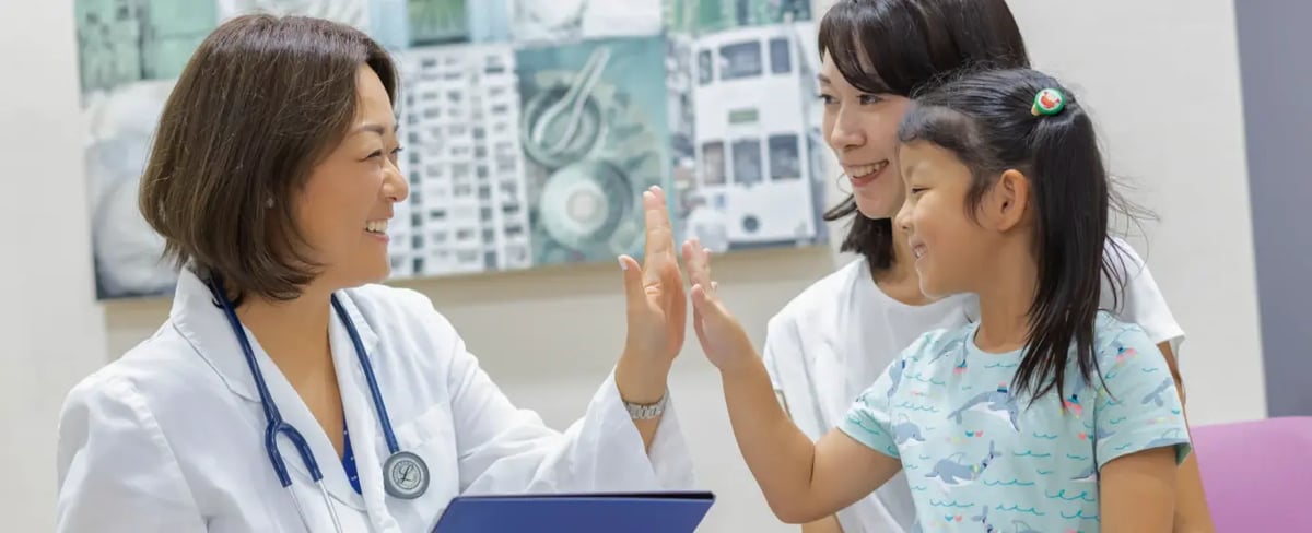 doctor high fiving female junior patient