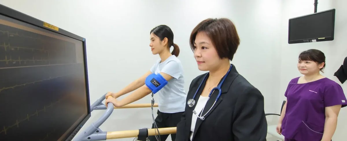 a doctor and a nurse leading a patient through ECG treadmill test