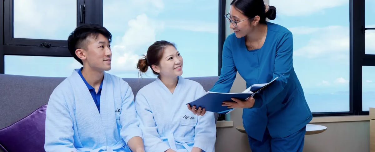 nurse running through test results with young couple