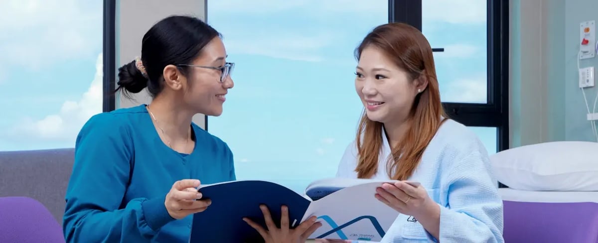 nurse running through health check results with female patient